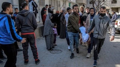 Palestinians carry away the body of a man killed in Israeli bombardment from the morgue of the Al-Shifa hospital in Gaza City (AFP) Palestinians carry away the body of a man killed in Israeli bombardment from the morgue of the Al-Shifa hospital in Gaza City (AFP)