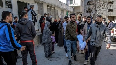 Palestinians carry away the body of a man killed in Israeli bombardment (AFP) Palestinians carry away the body of a man killed in Israeli bombardment (AFP)