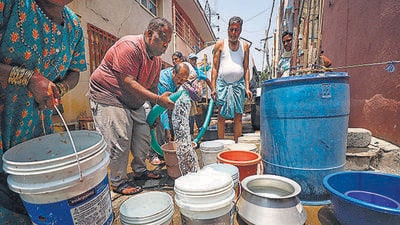 People collecting drinking water from a water tanker amid the ongoing water crisis in Karnataka, in Bengaluru,on Monday. (PTI) People collecting drinking water from a water tanker amid the ongoing water crisis in Karnataka, in Bengaluru,on Monday. (PTI)
