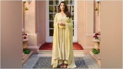 The Anjul Bhandari anarkali suit features an anarkali kurta. It comes with a round neckline featuring a front slit, full-length sleeves, a fit and flare silhouette, a scalloped hem, a slit on the front, and a relaxed fitting. The intricate chikankari embroidery, sequin embellishments, and beadwork in floral patterns further beautified the ethnic look. (Instagram) The Anjul Bhandari anarkali suit features an anarkali kurta. It comes with a round neckline featuring a front slit, full-length sleeves, a fit and flare silhouette, a scalloped hem, a slit on the front, and a relaxed fitting. The intricate chikankari embroidery, sequin embellishments, and beadwork in floral patterns further beautified the ethnic look. (Instagram)