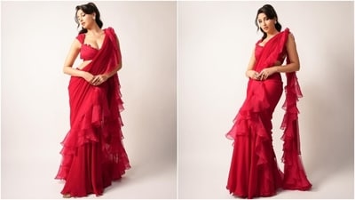 Nora Fatehi's ethnic looks never fail to leave her fans swooning. Recently, she shared photos of another look that featured her in a red ruffled saree by designer Ridhi Mehra. She styled it with a cropped blouse featuring a plunging neckline, a lace design on the neck, and a cropped silhouette. (Instagram) Nora Fatehi's ethnic looks never fail to leave her fans swooning. Recently, she shared photos of another look that featured her in a red ruffled saree by designer Ridhi Mehra. She styled it with a cropped blouse featuring a plunging neckline, a lace design on the neck, and a cropped silhouette. (Instagram)