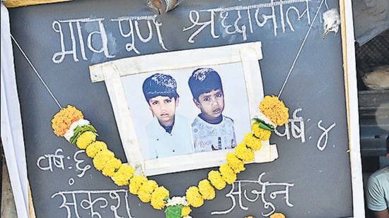 Mumbai, India - March 18, 2024: Mother Sonu manoj kavtiya, resident of Subhas Nagar, Wadala bridge, sits beside notice board, after her 2 sons, Ankush age 6 and Arjun age 4, died due to drowning in open water tank yesterday, at Maharshi Karve Udyan at Wadala, in Mumbai, India, on Monday, March 18, 2024. (Photo by Anshuman Poyrekar/ Hindustan Times) (Hindustan Times)