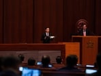 Hong Kong's Chief Executive John Lee, center, speaks to lawmakers following the passing of the Basic Law Article 23 legislation