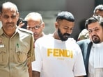 Conman Sukesh Chandrashekhar leaves after being produced at Patiala House court in connection with a money laundering case, in New Delhi earlier.