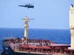 Pirates detained by the Indian navy during a rescue operation for the hijacked ship MV Ruen sit on the deck in this handout image released on March 16, 2024. 