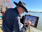A painter works on his image of  the Tidal Basin and Jefferson Memorial during Cherry Blossoms season on the National Mall in Washington, DC, on March 16, 2024. The vernal equinox happens on March 19, 2024, at 23h06 EDT (03h06 GMT, March 20) , marking the astronomical beginning of the spring season in the Northern Hemisphere and the autumn season in the Southern Hemisphere. (Photo by Daniel SLIM / AFP)