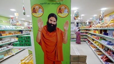 A hoarding with an image of Baba Ramdev is seen inside a Patanjali store in Ahmedabad. (Reuters file photo) A hoarding with an image of Baba Ramdev is seen inside a Patanjali store in Ahmedabad. (Reuters file photo)