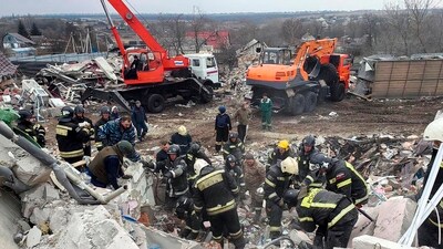 Emergency ministry employees working at the destroyed building after shelling from the Ukrainian side, in Nikolskoye village, Belgorod region, Russia. (AP)