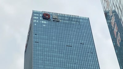A partially removed company logo of China Evergrande Group is seen on the facade of its headquarters in Shenzhen, Guangdong province, China. (Reuters)