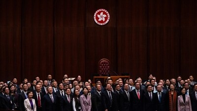 Hong Kong's Chief Executive John Lee, fifth foreground left, pose for photographs with lawmakers following the passing of the Basic Law Article 23 legislation (AP) Hong Kong's Chief Executive John Lee, fifth foreground left, pose for photographs with lawmakers following the passing of the Basic Law Article 23 legislation (AP)