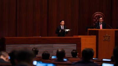 Hong Kong's Chief Executive John Lee, center, speaks to lawmakers following the passing of the Basic Law Article 23 legislation (AP)