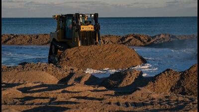 and is moved onto the beach during a nourishment project in Wrightsville Beach, North Carolina. Beach nourishment, or beach filling, is the practice of adding large quantities of sand or sediment to beaches to combat erosion and increase beach width. (AFP) and is moved onto the beach during a nourishment project in Wrightsville Beach, North Carolina. Beach nourishment, or beach filling, is the practice of adding large quantities of sand or sediment to beaches to combat erosion and increase beach width. (AFP)