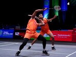 India's Chirag Shetty, background, and India's Satwiksairaj Rankireddy in action 