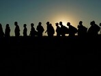 FILE - Migrants who crossed the Rio Grande and entered the U.S. from Mexico are lined up for processing by U.S. Customs and Border Protection, Sept. 23, 2023, in Eagle Pass, Texas. 