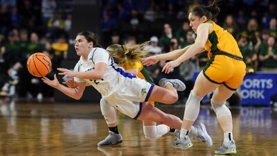 South Dakota State guard Paige Meyer (21) falls while driving between North Dakota State players during an NCAA college basketball game for the Summit League women's tournament championship Tuesday, March 12, 2024, in Sioux Falls, S.D. (Samantha Laurey/The Argus Leader via AP) (AP) South Dakota State guard Paige Meyer (21) falls while driving between North Dakota State players during an NCAA college basketball game for the Summit League women's tournament championship Tuesday, March 12, 2024, in Sioux Falls, S.D. (Samantha Laurey/The Argus Leader via AP) (AP)