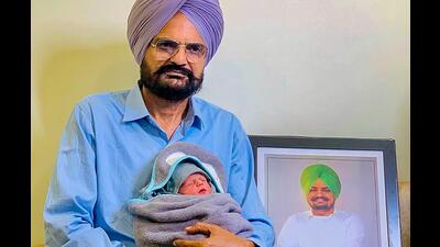 Balkaur Singh with his newborn in Bathinda. (PTI) Balkaur Singh with his newborn in Bathinda. (PTI)