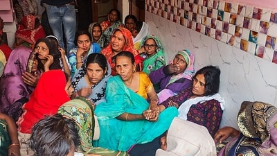Family members and relatives mourn after two boys were killed by a local barber on Tuesday, in Badaun on Wednesday. (PTI) Family members and relatives mourn after two boys were killed by a local barber on Tuesday, in Badaun on Wednesday. (PTI)