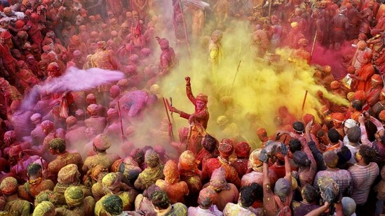 Lathmar Holi in Barsana, Uttar Pradesh: In Barsana, women playfully beat men with sticks in a reenactment of Lord Krishna's teasing of Radha. This colourful ritual symbolizes love and adds a playful twist to the celebrations.&nbsp;(REUTERS)