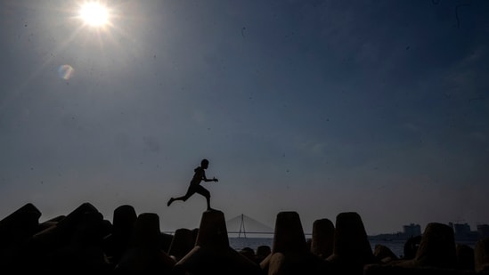 Mumbai, India - March 20, 2024: A boy Jumping in the afternoon heat as temperature soars at Dadar chowpatty in Mumbai, India, on Wednesday, March 20, 2024. (Photo by Satish Bate/ Hindustan Times) (Hindustan Times)