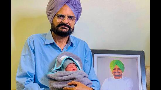 Balkaur Singh with his newborn in Bathinda. (PTI)