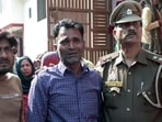 Father of the Budaun Double Murder victims being consoled by police official, in Budaun on Wednesday. 