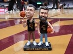 A bobblehead of Cleveland natives Travis and Jason Kelce. (AP Photo/Sue Ogrocki)