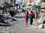 Palestinians walk past the ruins of houses destroyed during Israel's military offensive, amid the ongoing conflict between Israel and Hamas, in Gaza City. (Reuters)