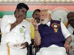 Prime Minister Narendra Modi speaks with Tamil Nadu BJP chief K. Annamalai during a public meeting in Salem, Tamil Nadu on Tuesday. (ANI)