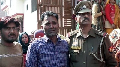 Father of the Budaun Double Murder victims being consoled by police official, in Budaun on Wednesday. (ANI) Father of the Budaun Double Murder victims being consoled by police official, in Budaun on Wednesday. (ANI)
