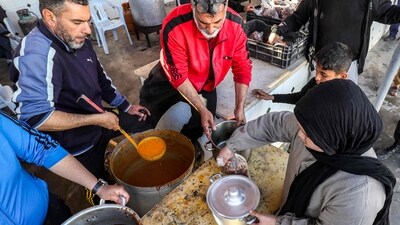 In the coastal city of Tajura, east of Tripoli, volunteers are serving portions of Bazin, a traditional Libyan dish made with barley, water, and salt. This meal, akin to Italian polenta or West African fufu, is being distributed to needy families during the Muslim holy fasting month of Ramadan. Bazin, originally a Berber dish, is a classic family meal from Tripolitania, the historic northwestern region of Libya. (AFP) In the coastal city of Tajura, east of Tripoli, volunteers are serving portions of Bazin, a traditional Libyan dish made with barley, water, and salt. This meal, akin to Italian polenta or West African fufu, is being distributed to needy families during the Muslim holy fasting month of Ramadan. Bazin, originally a Berber dish, is a classic family meal from Tripolitania, the historic northwestern region of Libya. (AFP)