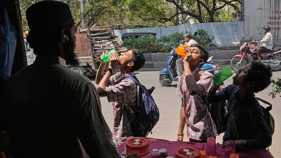 School children drink water at a roadside stall distributing free drinking water next to a bus stand in Hyderabad, India, Wednesday, March 22, 2017. People in many parts of India provide free drinking water to commuters during summer months. Friday marks the World Water Day. (AP Photo/Mahesh Kumar A.) (AP)