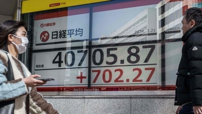 People walk past an electronic board showing a share price of the Nikkei index of the Tokyo Stock Exchange in Tokyo. (AFP) People walk past an electronic board showing a share price of the Nikkei index of the Tokyo Stock Exchange in Tokyo. (AFP)