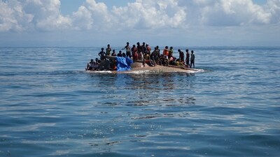 Rohingya refugees are seen on a capsized boat before being rescued in the waters of West Aceh, Indonesia. (REUTERS)