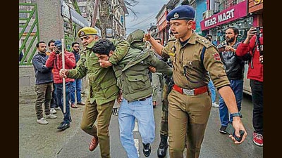 Police detain an AAP worker during a protest against the arrest of Arvind Kejriwal, in Srinagar on Friday. (AP) Police detain an AAP worker during a protest against the arrest of Arvind Kejriwal, in Srinagar on Friday. (AP)