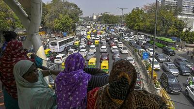 Women look on as vehicular traffic leads to congestion at ITO owing to protests by AAP against the arrest of Delhi chief minister Arvind Kejriwal, on Friday. (Raj K Raj/HT Photo) Women look on as vehicular traffic leads to congestion at ITO owing to protests by AAP against the arrest of Delhi chief minister Arvind Kejriwal, on Friday. (Raj K Raj/HT Photo)