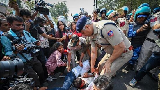 AAP leader Atishi being detained during the protest on Friday. (Sanchit Khanna/HT Photo)