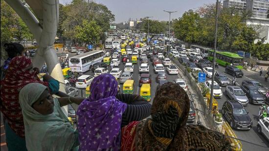 Women look on as vehicular traffic leads to congestion at ITO owing to protests by AAP against the arrest of Delhi chief minister Arvind Kejriwal, on Friday. (Raj K Raj/HT Photo)