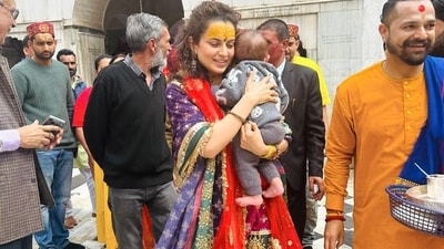 Some of the pictures also show her carrying her nephew in her arms lovingly as she walks through the temple. (Instagram) Some of the pictures also show her carrying her nephew in her arms lovingly as she walks through the temple. (Instagram)