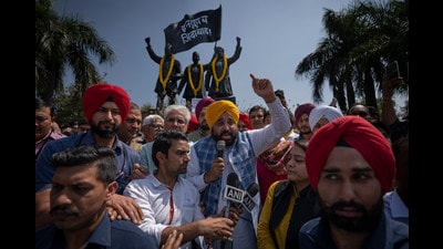 Punjab CM Bhagwant Mann (in yellow turban), addresses a protest rally in New Delhi on Saturday. (AP) Punjab CM Bhagwant Mann (in yellow turban), addresses a protest rally in New Delhi on Saturday. (AP)