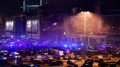 Emergency services personnel and servicemen are seen outside the Crocus City Hall concert hall following the shooting incident (AFP)