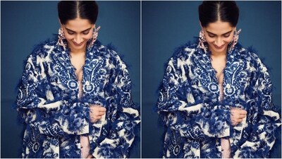 Complementing her stunning look, she pulled her lustrous long locks into a centre-pinned, neat bun, adding a touch of class to her mesmerising ensemble and making her look a true showstopper. (Instagram/@sonamkapoor) Complementing her stunning look, she pulled her lustrous long locks into a centre-pinned, neat bun, adding a touch of class to her mesmerising ensemble and making her look a true showstopper. (Instagram/@sonamkapoor)