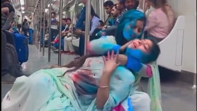 Snapshot of the women putting holi colours on each other inside Delhi metro Snapshot of the women putting holi colours on each other inside Delhi metro