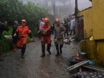 Members of the civil defense carry a girl, who remained under the rubble of her house for more than 12 hours. The house was destroyed by the heavy rains in Petropolis, Brazil on Saturday. Members of the civil defense carry a girl, who remained under the rubble of her house for more than 12 hours. The house was destroyed by the heavy rains in Petropolis, Brazil on Saturday.