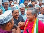 Thiruvananthapuram: Congress leader Shashi Tharoor joins AAP workers during their protest against the arrest of Delhi CM Arvind Kejriwal.(PTI)