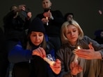 People light candles in memory of the victims of the terrorist attack in Moscow.