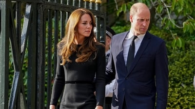 Britain's Prince William, second left, Kate, Princess of Wales, left, Britain's Prince Harry, second right, and Meghan, Duchess of Sussex view the floral tributes for the late Queen Elizabeth II outside Windsor Castle, in Windsor, England on Sept. 10, 2022. (AP Photo/Martin Meissner, File) (AP) Britain's Prince William, second left, Kate, Princess of Wales, left, Britain's Prince Harry, second right, and Meghan, Duchess of Sussex view the floral tributes for the late Queen Elizabeth II outside Windsor Castle, in Windsor, England on Sept. 10, 2022. (AP Photo/Martin Meissner, File) (AP)