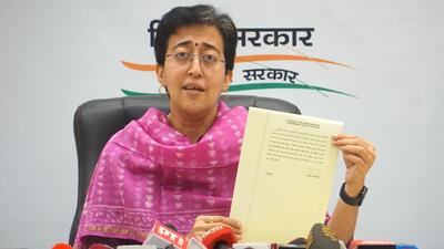 Delhi cabinet minister Atishi shows chief minister Arvind Kejriwal's direction from ED custody on resolving the city’s water concerns during a press conference in Delhi on Sunday. (PTI)