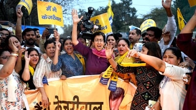 Delhi education minister Atishi with AAP supporters at a protest in New Delhi on Sunday. (ANI)
