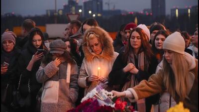 People lay flowers and light candles near the Crocus City Hall in Moscow on Saturday. (AP) People lay flowers and light candles near the Crocus City Hall in Moscow on Saturday. (AP)