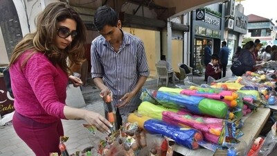 Tourists join Holi frenzy: Delhi markets abuzz with last-minute shoppers for colours, water guns and political masks (Saneev Verma/HT PHOTO) Tourists join Holi frenzy: Delhi markets abuzz with last-minute shoppers for colours, water guns and political masks (Saneev Verma/HT PHOTO)